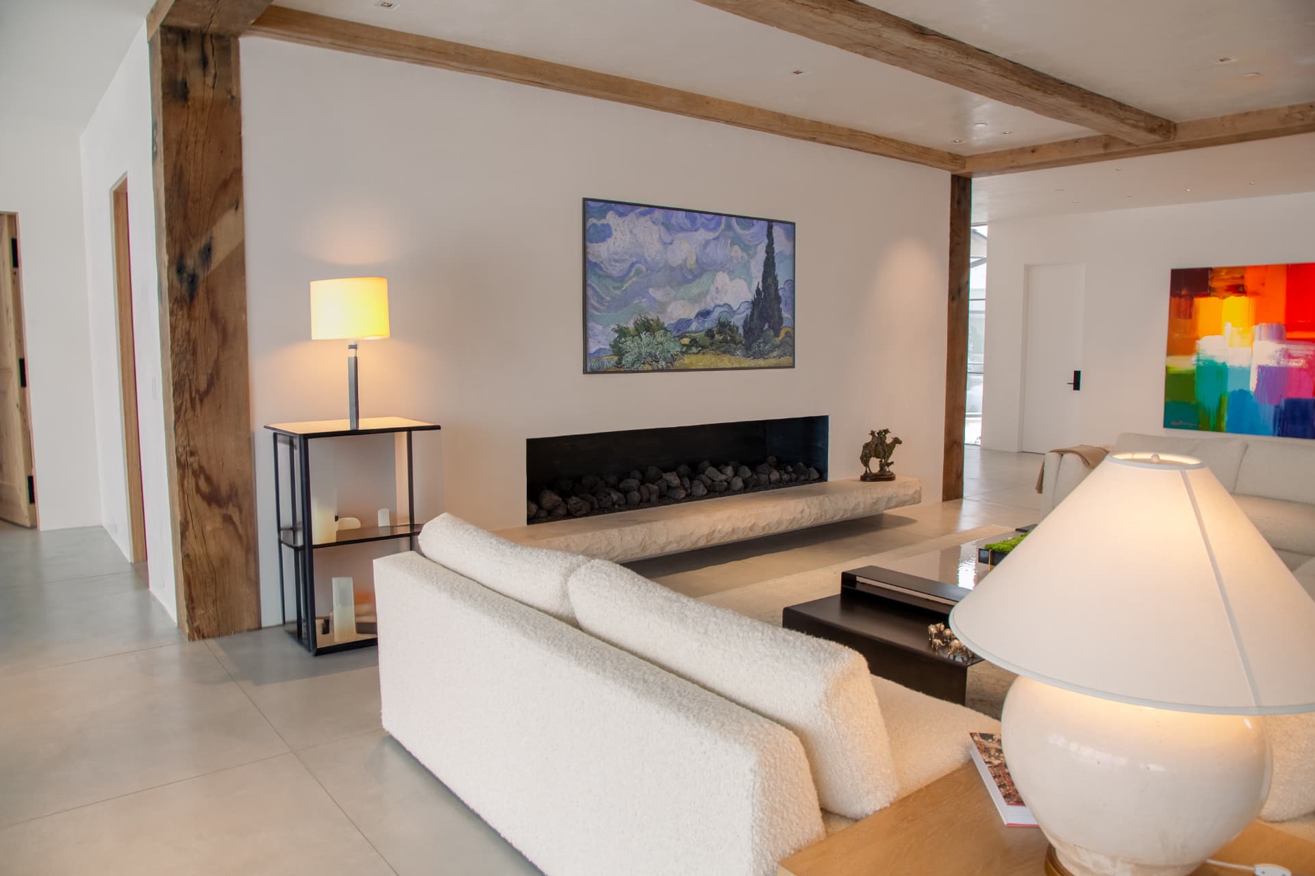 Minimalist living room with an art-mode display above a long linear fireplace