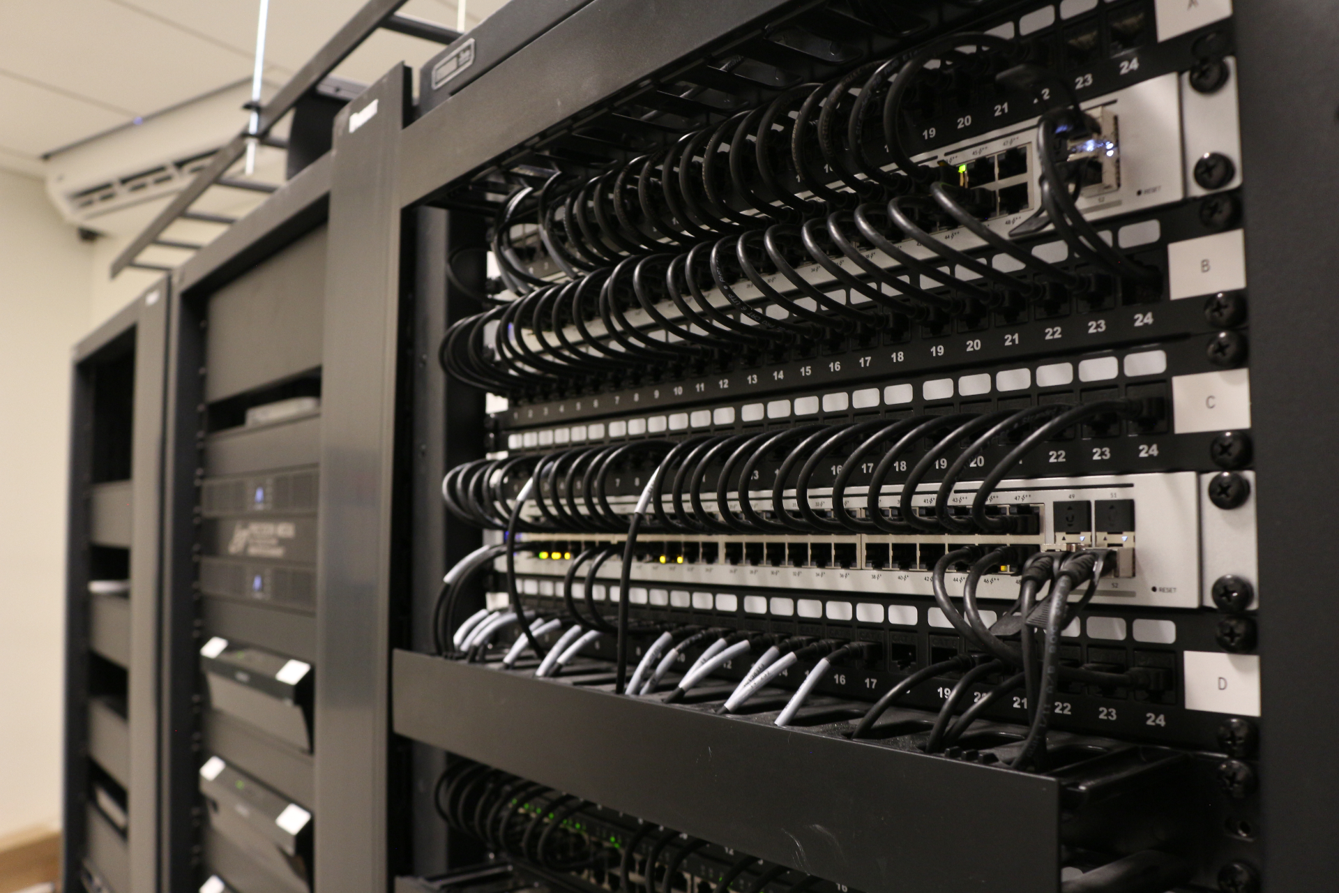 Commercial-grade residential network rack with neatly dressed patch cables and switches