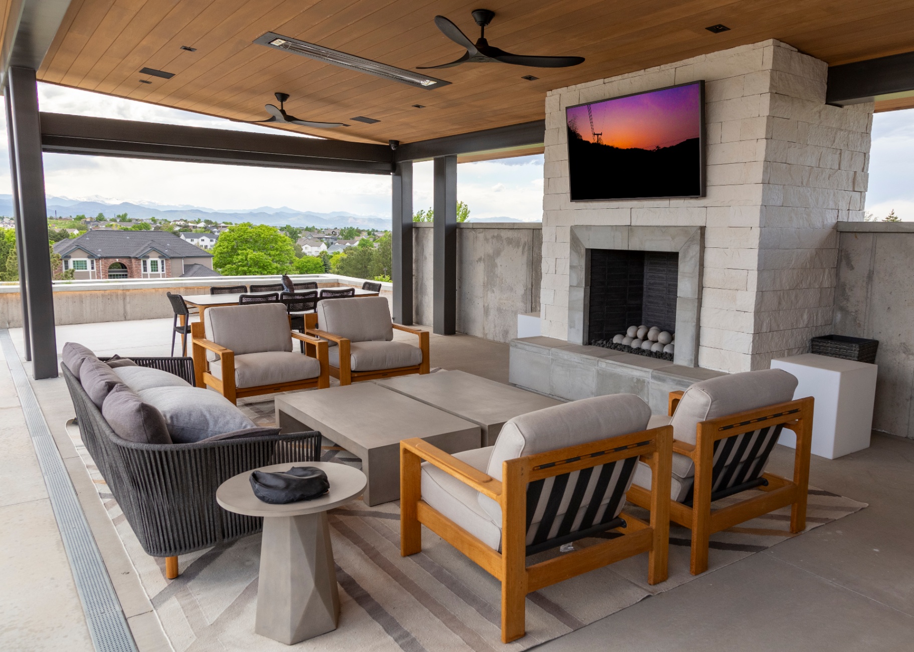 Covered patio lounge with outdoor television and mountain view