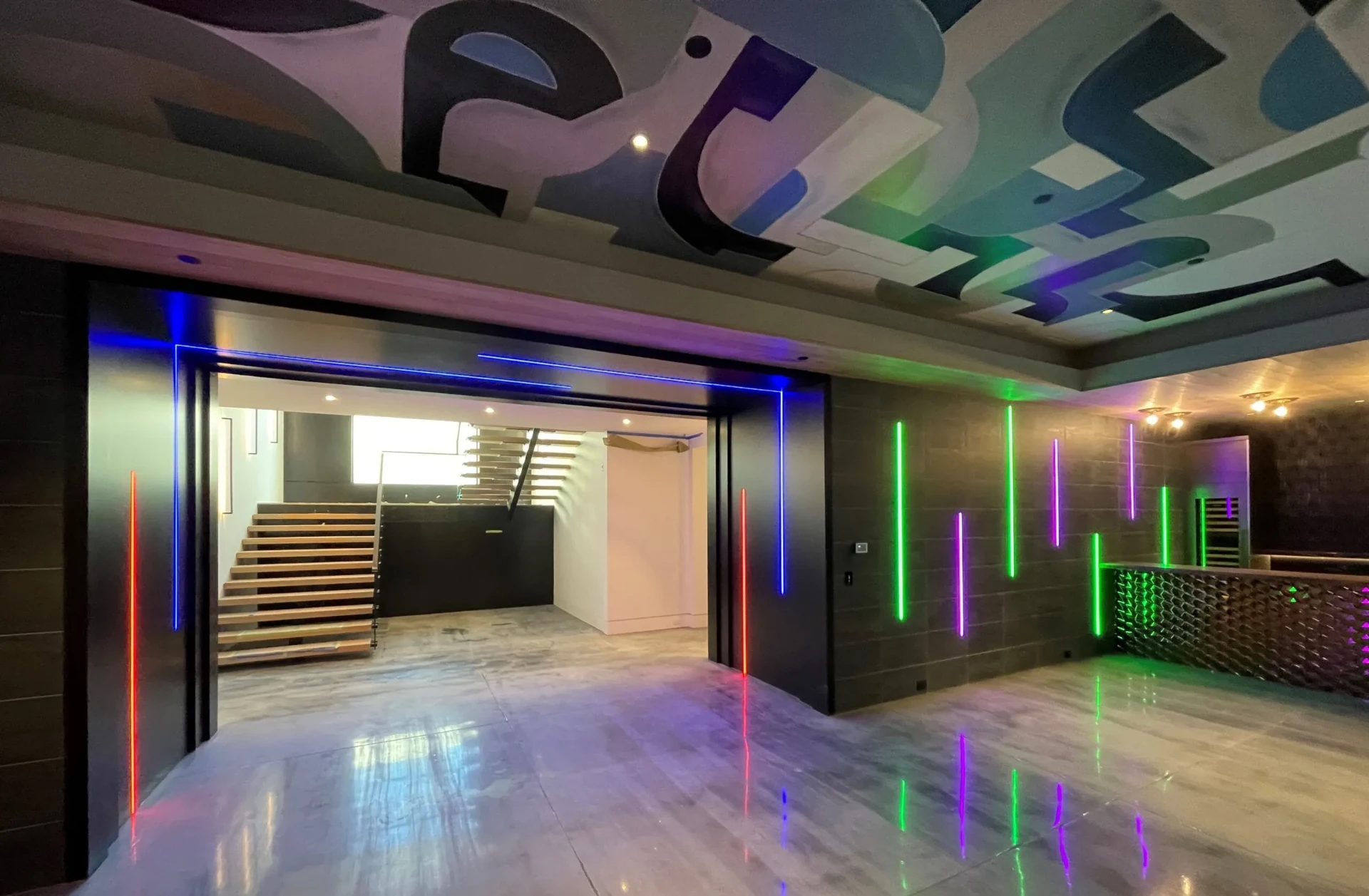 Custom RGB lighting installation washing walls and ceiling with vibrant color