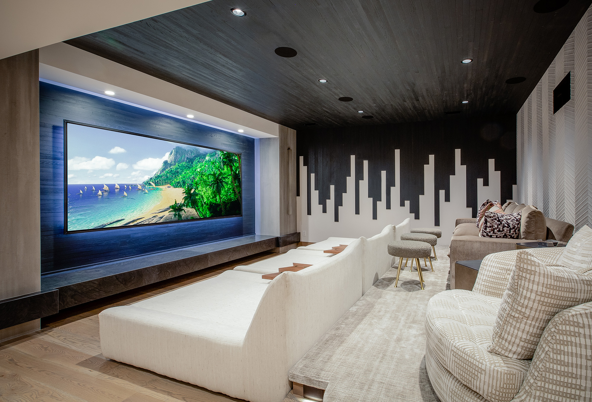 High-end home theater with oversized screen and tiered lounge seating