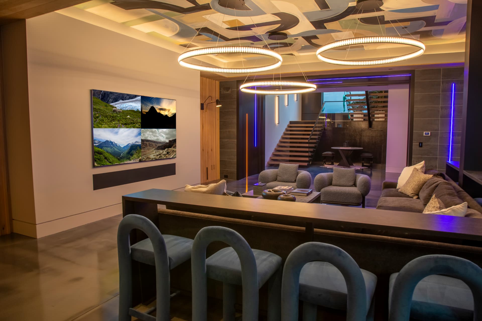 Bar lounge with ring fixtures, artistic ceiling, and a large wall-mounted display