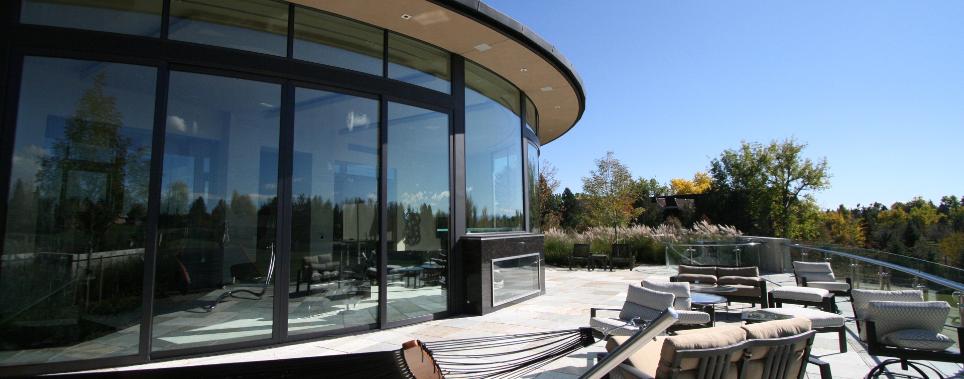 Modern luxury home with seamless indoor-outdoor living and panoramic glass