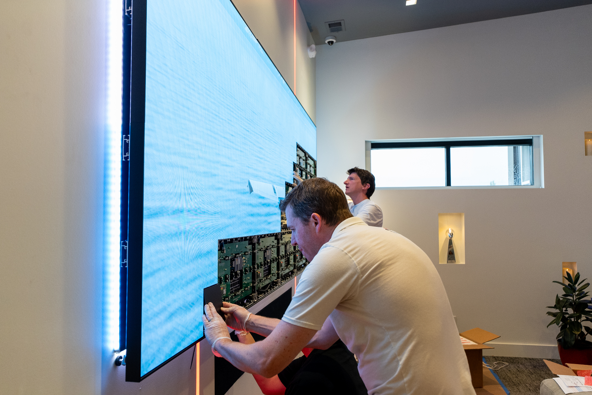 Precision Media technicians servicing a large LED video wall