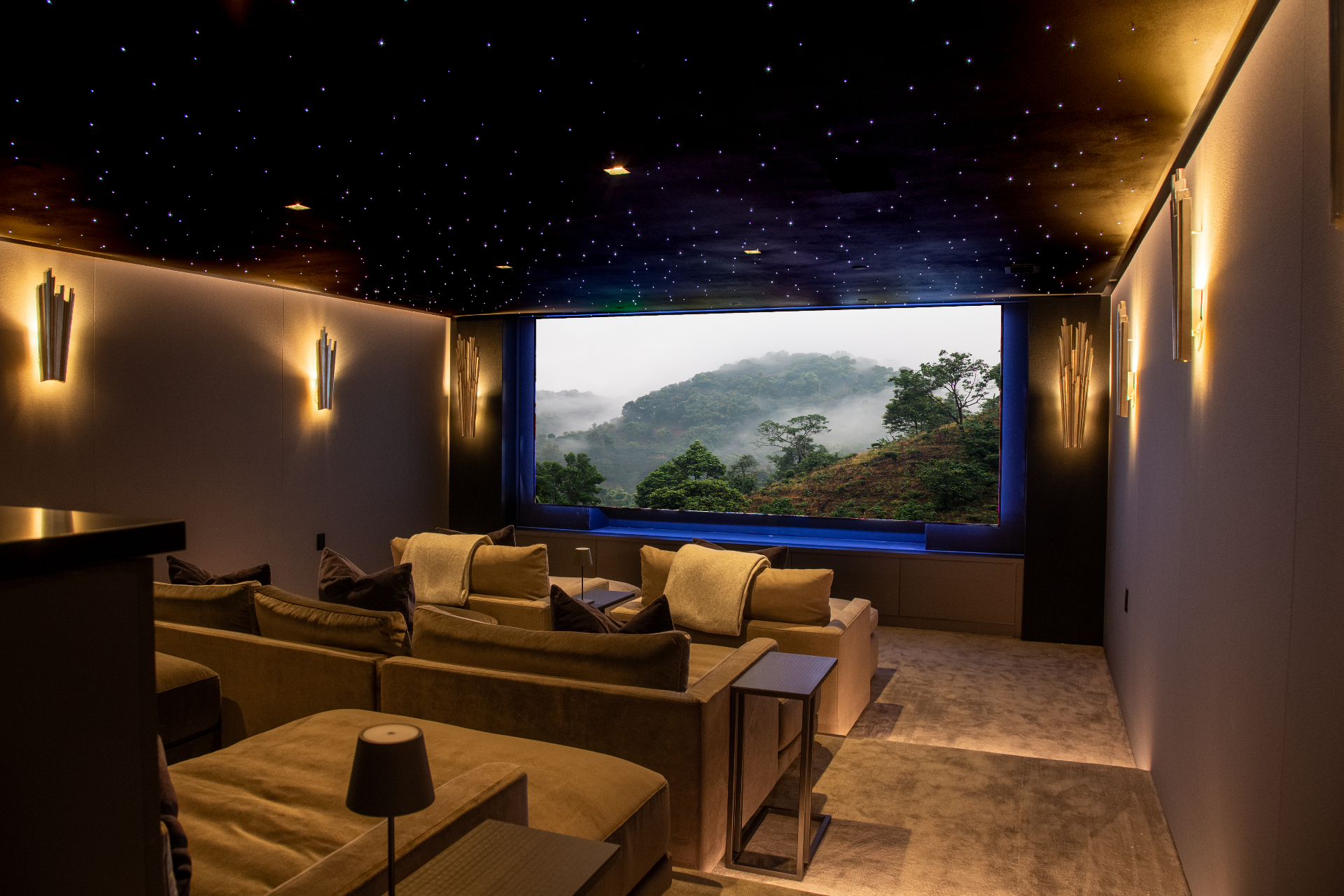 Luxury theater room with fiber-optic star ceiling and large projection screen