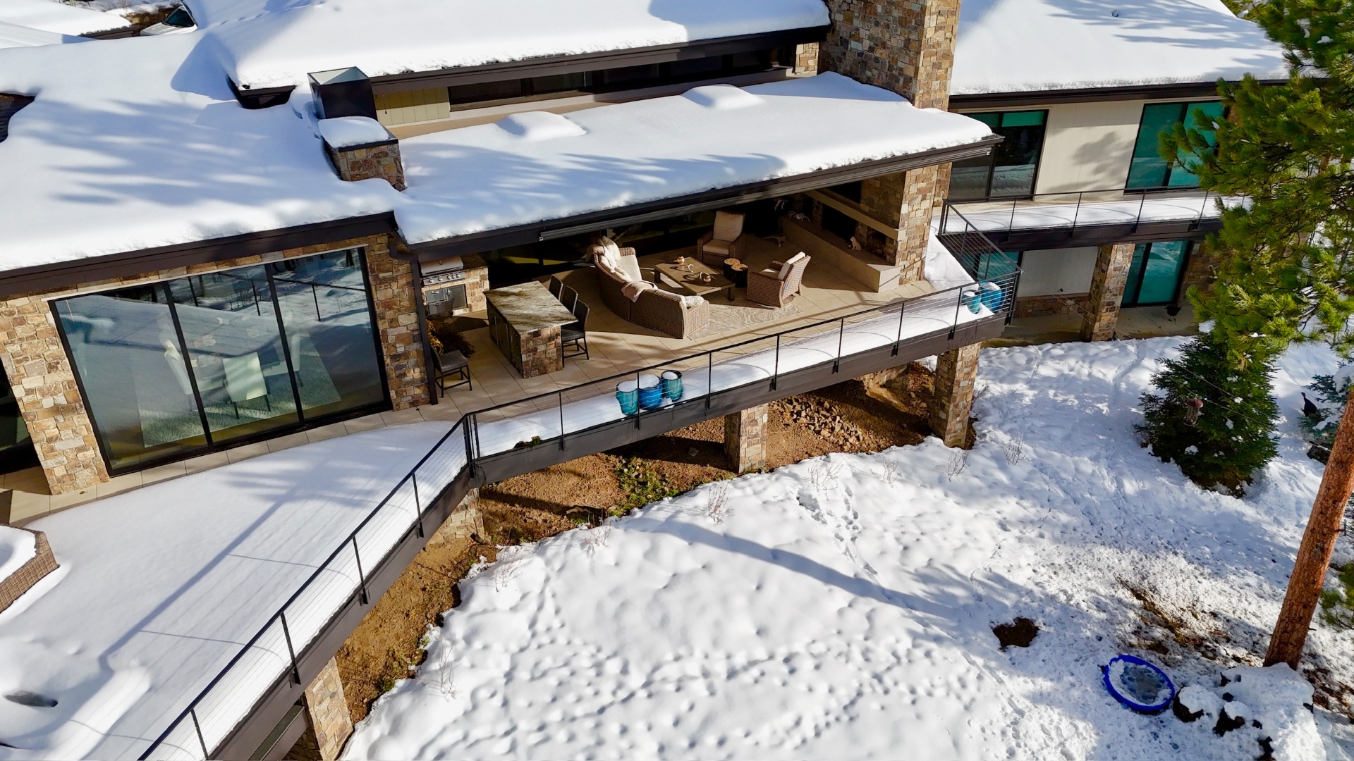 Snow-covered Colorado mountain estate with integrated outdoor entertainment
